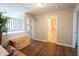 Hallway with laminate wood flooring, light beige walls, with a chest against the railing at 1266 Hamilton Dr, Greenwood, IN 46143