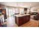 Open-concept kitchen island with granite countertops, seamlessly connecting to the living and dining areas at 1266 Hamilton Dr, Greenwood, IN 46143