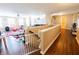 Bright and spacious living area with hardwood floors, white railing, and stairs at 1266 Hamilton Dr, Greenwood, IN 46143