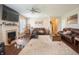 Spacious living room with fireplace, hardwood floors, fan, and multiple leather couches at 1266 Hamilton Dr, Greenwood, IN 46143