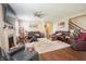 Spacious living room with fireplace, hardwood floors, fan, and multiple leather couches at 1266 Hamilton Dr, Greenwood, IN 46143