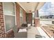 Inviting front porch featuring comfortable seating, perfect for enjoying the outdoors, with brick columns at 1266 Hamilton Dr, Greenwood, IN 46143