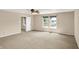 Large bedroom with a ceiling fan and neutral colored walls and carpet, with an ensuite bathroom at 14373 Orange Blossom Trl, Fishers, IN 46038