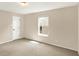 Bright carpeted bedroom with a large window, closet, and neutral walls, offering a comfortable and versatile space at 14373 Orange Blossom Trl, Fishers, IN 46038