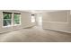 Large open bonus room with windows offering ample natural light and neutral carpeting throughout at 14373 Orange Blossom Trl, Fishers, IN 46038