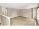 Large bonus room upstairs with neutral paint, carpet, and natural light from the window at 14373 Orange Blossom Trl, Fishers, IN 46038
