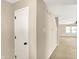 A well-lit hallway with neutral walls leads to an open space with a carpeted floor at 14373 Orange Blossom Trl, Fishers, IN 46038