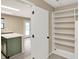 Bright, open kitchen features a white island with green cabinetry and a doorway that provides ample storage space at 14373 Orange Blossom Trl, Fishers, IN 46038