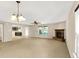 Spacious living room featuring neutral walls, a ceiling fan and a stone fireplace at 14373 Orange Blossom Trl, Fishers, IN 46038