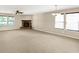 Spacious living room featuring neutral walls, a ceiling fan and a stone fireplace at 14373 Orange Blossom Trl, Fishers, IN 46038