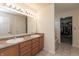 Bathroom featuring a double sink vanity and a view into the walk-in closet and soaking tub at 2458 Bristol Dr, Franklin, IN 46131