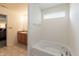 Bright bathroom featuring a soaking tub, privacy window, and wood vanity at 2458 Bristol Dr, Franklin, IN 46131