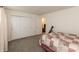 Bedroom with closet, white trim, and a patterned bedspread and adjacent doorway at 2458 Bristol Dr, Franklin, IN 46131
