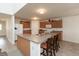 Functional kitchen with a central island, wooden cabinets, and essential white appliances, perfect for daily living at 2458 Bristol Dr, Franklin, IN 46131