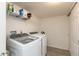Bright laundry room with washer, dryer, shelving, and tiled flooring at 2458 Bristol Dr, Franklin, IN 46131