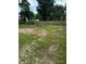 A spacious backyard features grass and some rock and is surrounded by a wooden fence at 2907 Baltimore Ave, Indianapolis, IN 46218