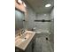 This renovated bathroom has modern fixtures, a marble tiled floor and shower with tub at 2907 Baltimore Ave, Indianapolis, IN 46218