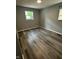 This bedroom features hardwood floors, neutral colored walls and two windows at 2907 Baltimore Ave, Indianapolis, IN 46218
