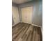 Bedroom featuring a closet with bi-fold doors, wood-look flooring, and gray walls at 2907 Baltimore Ave, Indianapolis, IN 46218