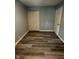 This bedroom features hardwood floors, neutral colored walls and a closet and door at 2907 Baltimore Ave, Indianapolis, IN 46218