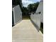 Long concrete driveway between two properties, leading to a fenced backyard at 2907 Baltimore Ave, Indianapolis, IN 46218
