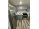 Kitchen featuring stainless steel appliances, gray cabinets, and laminate countertops at 2907 Baltimore Ave, Indianapolis, IN 46218