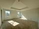 Spacious main bedroom with a tray ceiling and windows that let in plenty of natural light at 3110 Montgomery Blvd, Lapel, IN 46051