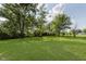 A lush green backyard with mature trees provides a peaceful outdoor space at 3120 S Meridian Rd, Greenfield, IN 46140