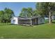 Exterior of home shows a spacious lawn and charming screened porch, perfect for relaxing at 3120 S Meridian Rd, Greenfield, IN 46140