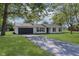 Charming single-story home with a well-manicured lawn and a long driveway at 3120 S Meridian Rd, Greenfield, IN 46140