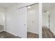 Bright laundry room with wood-look floors, modern sliding door and a designated area for a washer and dryer at 3120 S Meridian Rd, Greenfield, IN 46140