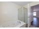 Relaxing bathroom featuring a soaking tub, shower, and neutral finishes at 3624 Newberry Rd, Plainfield, IN 46168