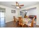 Inviting dining room featuring hardwood floors, a ceiling fan, and a view of the staircase and living room at 3624 Newberry Rd, Plainfield, IN 46168