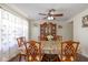 Bright dining room featuring hardwood floors, a ceiling fan, and a view of the front yard at 3624 Newberry Rd, Plainfield, IN 46168