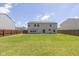 Back exterior showcasing a well-maintained yard, privacy fence, and traditional architecture at 3624 Newberry Rd, Plainfield, IN 46168
