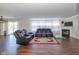 Spacious living room featuring dark wood floors, a fireplace, and cozy seating with a plush rug at 3624 Newberry Rd, Plainfield, IN 46168