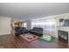 Spacious living room featuring dark wood floors, a fireplace, and cozy seating with a plush rug at 3624 Newberry Rd, Plainfield, IN 46168