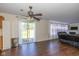 Open-concept living room showcasing dark wood floors, sliding glass doors, and a comfortable seating area at 3624 Newberry Rd, Plainfield, IN 46168