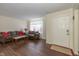 Comfortable living room with dark wood floors and a large brown sofa featuring red pillows at 3624 Newberry Rd, Plainfield, IN 46168