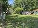 View of large backyard with an outbuilding, fire pit, and chain link fence at 4106 N Sherman Dr, Indianapolis, IN 46226