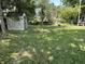 Backyard features an outbuilding for extra storage and mature trees for shade and privacy at 4106 N Sherman Dr, Indianapolis, IN 46226