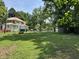 Large backyard surrounded by mature trees provides privacy, with a shed, perfect for storage at 4106 N Sherman Dr, Indianapolis, IN 46226