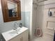 Bathroom featuring a vanity with a sink, a wood framed mirror, and a white stand-up shower at 4106 N Sherman Dr, Indianapolis, IN 46226