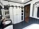 Black and white bathroom with storage, modern fixtures, and stylish design at 4106 N Sherman Dr, Indianapolis, IN 46226