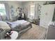 Cozy bedroom with patterned walls, natural light, and a comfortable seating area at 4106 N Sherman Dr, Indianapolis, IN 46226