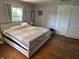 Spacious bedroom with hardwood floors, neutral walls, and bright natural light at 4106 N Sherman Dr, Indianapolis, IN 46226