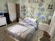 Bedroom with mural, natural light, patterned rug, and closet door at 4106 N Sherman Dr, Indianapolis, IN 46226