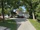 Gravel driveway with several cars parked leading to a garage and the home at 4106 N Sherman Dr, Indianapolis, IN 46226