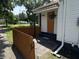Charming front porch with orange door, privacy fence, and hanging fern at 4106 N Sherman Dr, Indianapolis, IN 46226