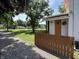 Quaint porch entrance features a pop of color with an orange front door and privacy fence at 4106 N Sherman Dr, Indianapolis, IN 46226